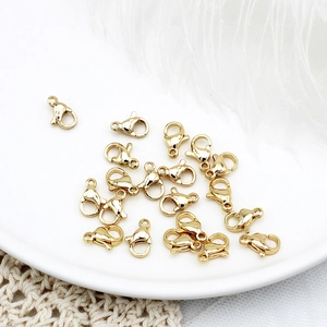Close-up of 18K gold plated lobster clasps for DIY jewelry making on white decor