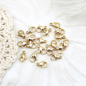 18K gold plated lobster clasps for DIY jewelry making sets on elegant white feathers