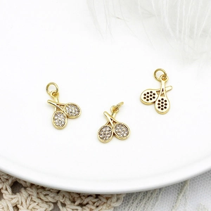Detailed macro view of 18K gold plated tennis racket pendants with sparkling zircon inlay