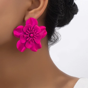 Detailed view of large vibrant rose pink floral earrings with multi-layered petal design