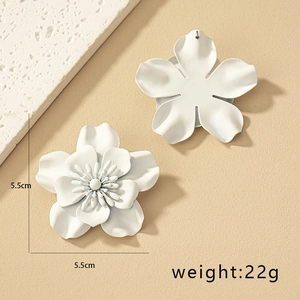 Detail view of large white floral earrings with matte finish and 5.5cm size markings