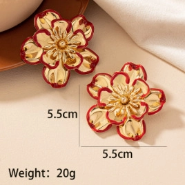 Detailed view of large gold floral earrings with red borders, 5.5cm size and 20g weight