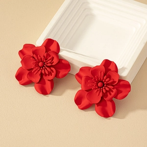 Matte red floral stud earrings with multi-layered petals in a minimalist setting