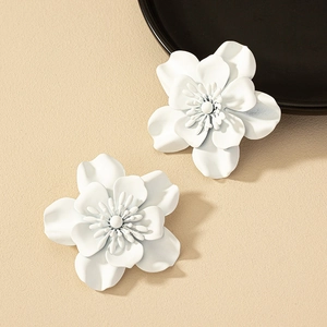 Elegant matte white floral stud earrings with multi-layer petals on beige background