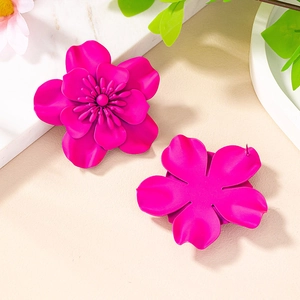 Macro detail of hot pink flower stud earrings with matte lacquer and multilayer petals