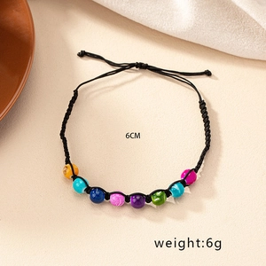 Detail view of handmade Bohemian multi-color beaded bracelet with adjustable black wax cord
