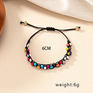 Detailed shot of handmade colorful beaded bracelet with adjustable rope and 6cm diameter