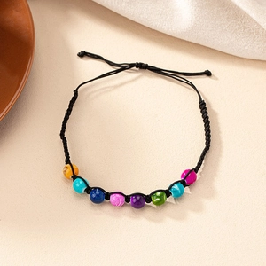 Detail of bohemian handmade beaded bracelet with adjustable black woven cord