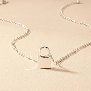 Minimalist silver padlock pendant necklace with smooth metallic finish on O-chain