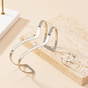 Polished silver wave jewelry set with double-layered open cuff bracelet and ring on stone