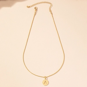 Close-up of golden alphabet A pendant with minimalist snake chain and lobster clasp