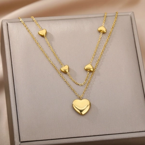 Golden double layer necklace featuring multiple heart pendants and polished finish