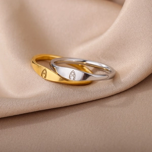 Elegant gold and silver stainless steel rings with letter A engraving on satin
