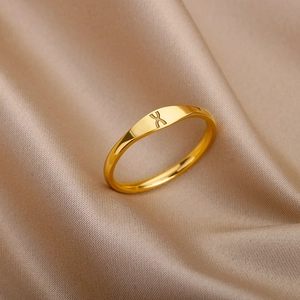 Minimalist gold stainless steel ring with engraved letter X on polished signet top