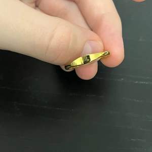 Detailed macro view of 18k gold plated stainless steel ring with custom letter engraving