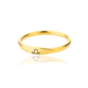 Macro shot of 18k gold plated stainless steel Libra zodiac sign ring with reflection