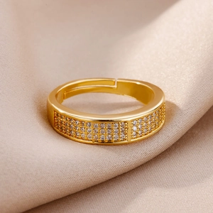 Macro detail of gold-plated snake ring with micro-pave zircons on champagne silk