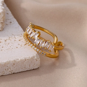 Detail of gold double-layer open ring featuring baguette and round cubic zirconia stones