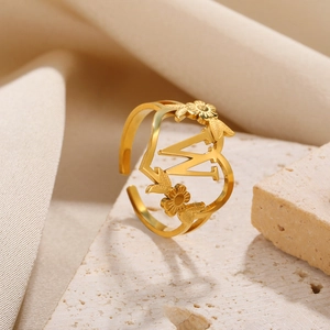 Detailaufnahme von 18k vergoldetem Herzring aus Edelstahl mit Blume und Buchstabe W