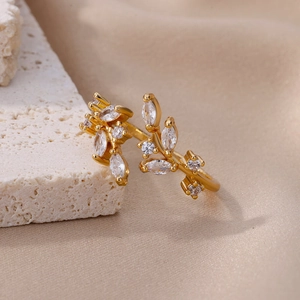 Detailed close-up of a gold leaf branch ring with sparkling marquise cut zircons