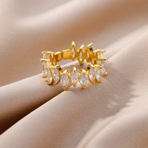 Macro view of gold plated multi-layer ring with marquise-cut zircon on satin fabric