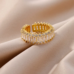 Macro shot of gold geometric layered ring with rectangular cubic zirconia on silk
