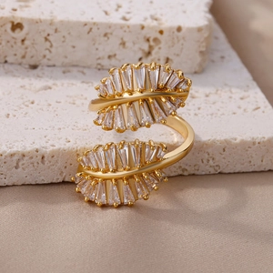 Macro detail of adjustable gold leaf ring with sparkling trapezoid zircon inlay