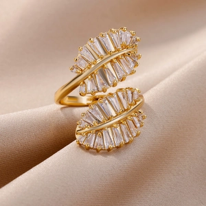 Detail view of gold branch ring with baguette-cut zircons on champagne silk