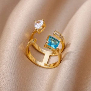 Detailed macro view of gold multi-layer ring with blue and clear zircon stones