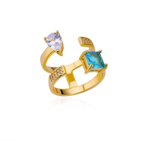Detailed macro of gold plated geometric ring with blue and clear zircon gemstones