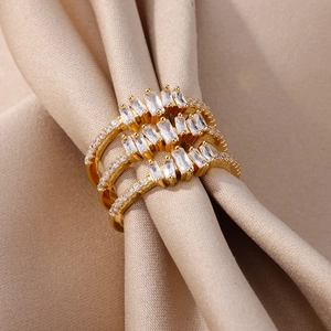 Detailed macro view of three layered gold-plated rings with rectangular zircon stones