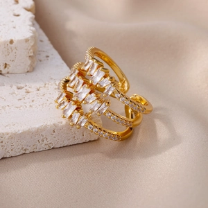 Detailed close-up of multi-layer gold-plated ring featuring rectangle cut cubic zirconia stones