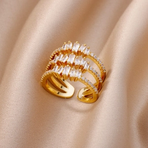 Macro shot of triple-layer gold ring with baguette and round cubic zirconia stones