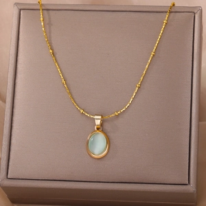 Elegant gold-tone beaded chain necklace featuring an oval cat-eye stone pendant in a gift box