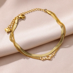 Double-layer gold figaro and snake chain anklet with heart pendant on pink silk
