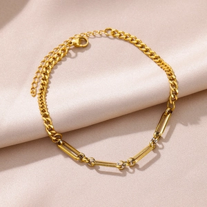 Detail of gold-plated Figaro and paperclip anklet chain with adjustable lobster clasp