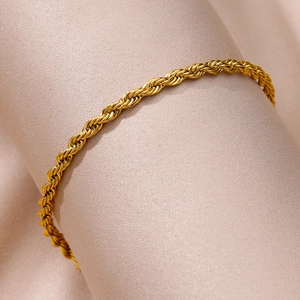 Detail of twisted rope chain anklet in 18k gold plated stainless steel on satin display