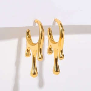 Detailed view of golden molten liquid drop earrings with high-gloss mirror finish metal