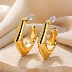 Polished gold drop earrings on stone base with satin fabric detail macro