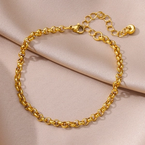 Detail of 18k gold plated Rolo chain anklet with lobster clasp and extension on champagne silk