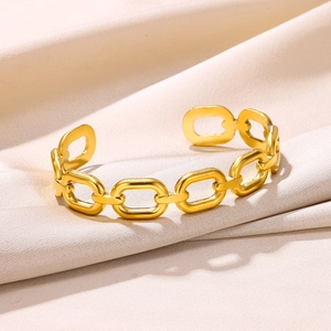 Detailed close-up of golden chain link bangle on elegant white satin background
