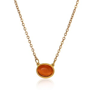 Detailed macro view of the golden chain showing the orange oval cat eye stone pendant