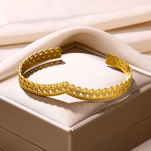Detailed view of adjustable gold-plated cuff bangle with vintage lace filigree pattern