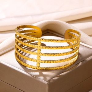 Detailed macro view of the gold-plated five-layer hollow line bangle with dotted textures