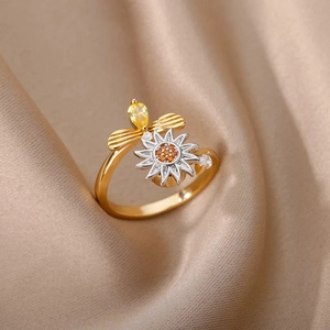 Detailed close-up of golden sunflower ring with bee design and shimmering zircon stones