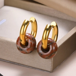 Detailed close-up of vintage gold hoop earrings with brown marble stone rings