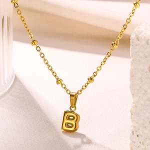 Detailed close-up of 18K gold plated bubble letter B pendant on a bead link chain
