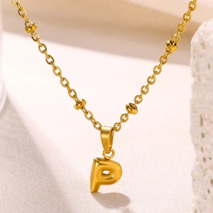 Detail of 18K gold plated bubble letter P pendant on a beaded O-chain necklace