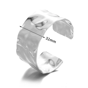 Detail view of 32mm wide cuff bracelet showing unique irregular hammered metal texture