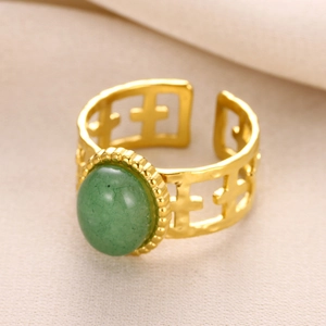 Detail of green natural stone ring with gold 18K plating and hollow cross design